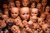 An abundance of white doll babies gathered together.
