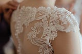 A white lace wedding dress with beautiful pearl buttons.