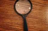 A magnifying glass on a wooden table