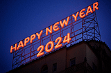 Happy New Year 2024 in a big bight red neon sign atop a building