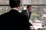 Businessman angrily grabbing the computer monitor to throw it.