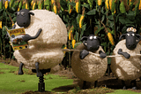 A gif from the Shaun the Sheep, where two sheep are unravelling the wool of a third sheep.