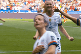 Megan Rapinoe celebrating a soccer game win.