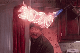 A gif of a man getting fire sprayed onto his head with the text “2020”
