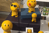 gif of Bouncy smiling faces on a display case (product is called Hoptimists)