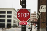 A stop sign on a street lamp with a smaller sign below that says “All Way.” Politics, family, Election2024, MAGA