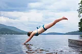 A person diving into a lake head first