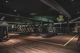 Line of empty treadmills in dark gym