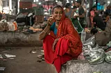 A South Asian woman is all smiles while sipping on chai