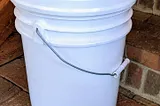 A plastic 5-gallon bucket with a gamma-seal lid
