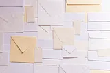 An array of different styles of envelopes arranged haphazardly.