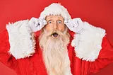 Santa Claus with a shocked expression, wide-eyed and open-mouthed, conveying surprise.