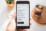 A cellphone in a woman’s hand with a purposeful statement: “I design and develop experiences that make people’s lives simple.”