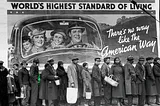 Margaret Bourke-White’s iconic WPA photo ‘World’s Highest Standard of Living,’ picturing a line of poor Black people standing in a breadline before a billboard proclaiming ‘The World’s Highest Standard of Living: there’s no way like the American Way’ around an image of a white, propserous family enjoying a drive in a large luxury car. The image has been altered so that the lined up workers and the family in the car blink in and out of existence, replaced by the ‘code rain’ effect from the Wachow
