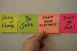 Post-It notes saying stay home, be safe, keep your distance, and don’t go out