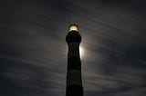 Lighthouse shining at night