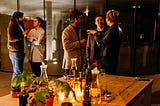 A scene of well dressed people socializing before dinner