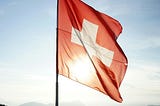 Switzerland flag at the top of a mountain