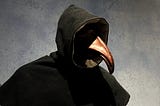 A person with a hood and a mask of a plague doctor