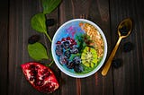 A vibrantly colourful bowl of fruits and granola