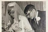 Young bride and groom cutting their wedding cake