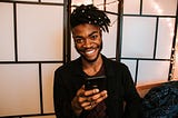 Smiling person with smart phone.