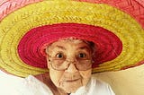An elderly diva in a colourful sombrero.
