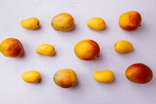 big and small size of mangoes are on table in line