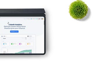 Shows a tablet with a screen showing a LinkedIn Analytics dashboard