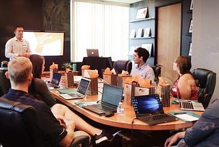 Marketers gathered around a desk planning a campaign