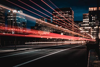 Trail of light beams from cars on a highway