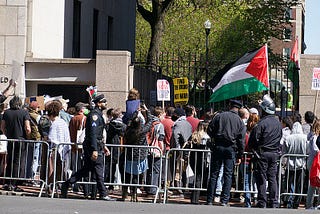 Protests in and around Columbia University in support of Palestine and against Israeli occupation. A side gate by the bookstore where the crowd is — inside and out.