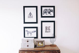Set of four hanging pictures with black frames
