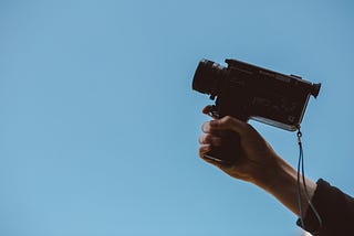 Holding video camera that’s pointed at the sky.