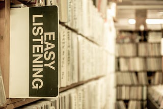 Easy listening sign in library book shelf. I’m A Good Listener But I Want To Solve Your Problem. Learning the lost art of just being there.