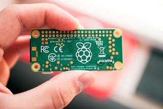 person holding a Raspberry Pi card