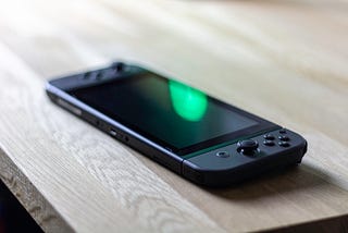 Photo of a black Nintendo Switch on a table