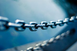 A chain link with another one in the background, Photo by JJ Ying on Unsplash