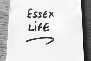 Black and white photo of a Post-It with ‘Essex Life’ written in black marker