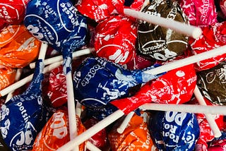 a ton of tootsie pops all different flavors and colors