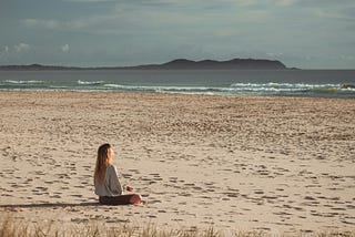 a woman meditates peacefully in the morning. we all need some mental strength in these difficult times.