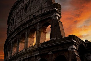 The Colosseum in Rome set against a sunset.