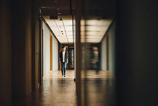 A child walking down a dark hallway.
