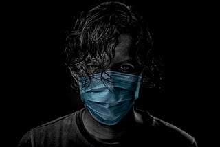 Eery photo of a man an in a medical mask