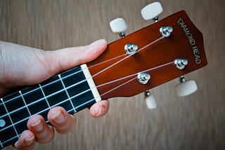 A hand holding a guitar