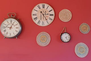 Wall with several clocks on it