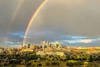 Double rainbows over a city.