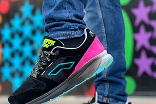 Person wearing colourful sneakers.