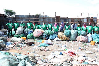 A handful of the fantastic waste collectors from our clean-up in Arusha with the waste collected during the clean-up.
