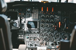View of an airplane cockpit, showing lots of gauges